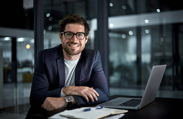 Portrait of a happy young businessman working at his office desk